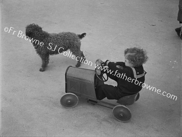 CHILD WITH TOY CAR AND DOG